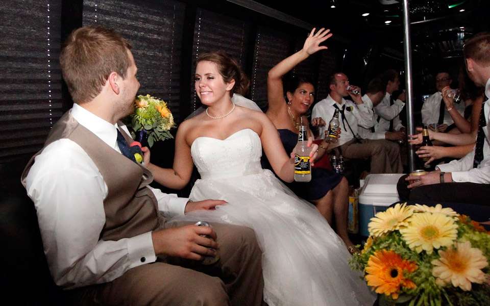 Bride having fun in limo bus