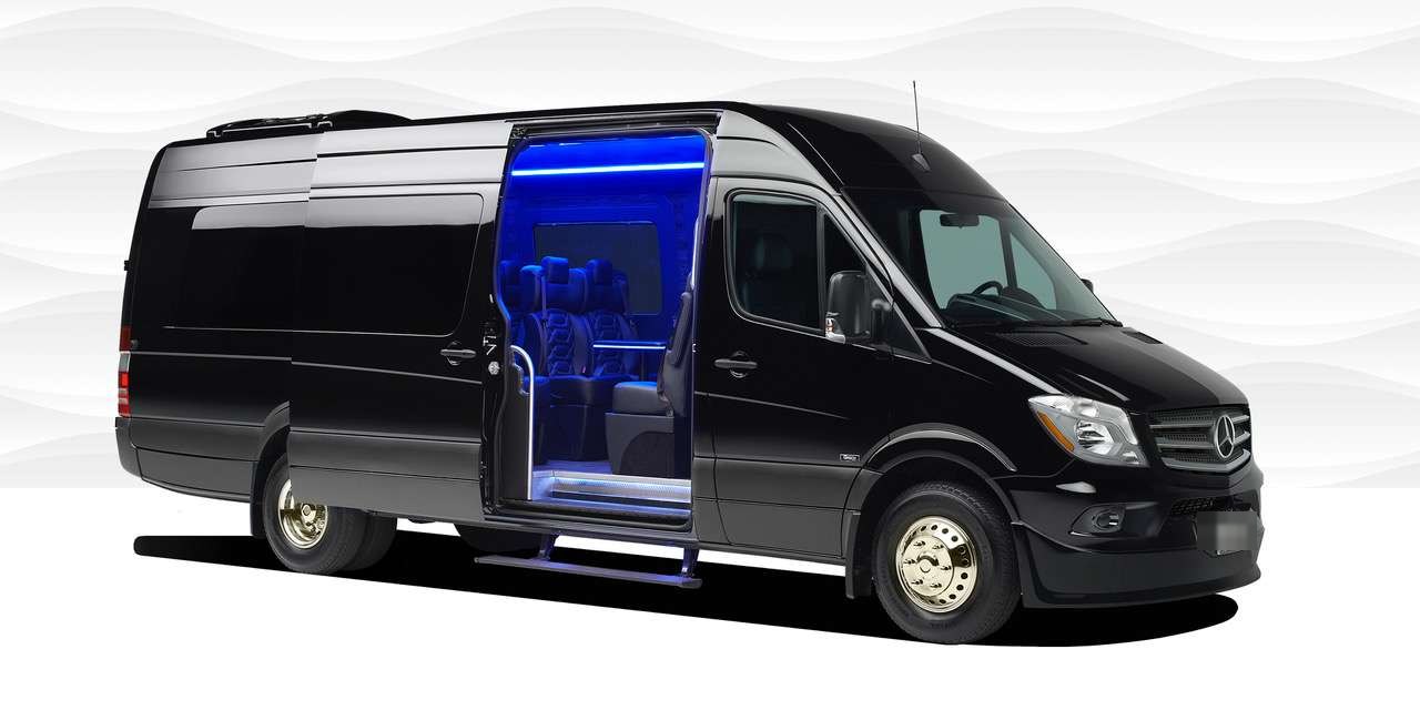 Black Mercedes-Benz Sprinter van with sliding door open to a blue-lit interior