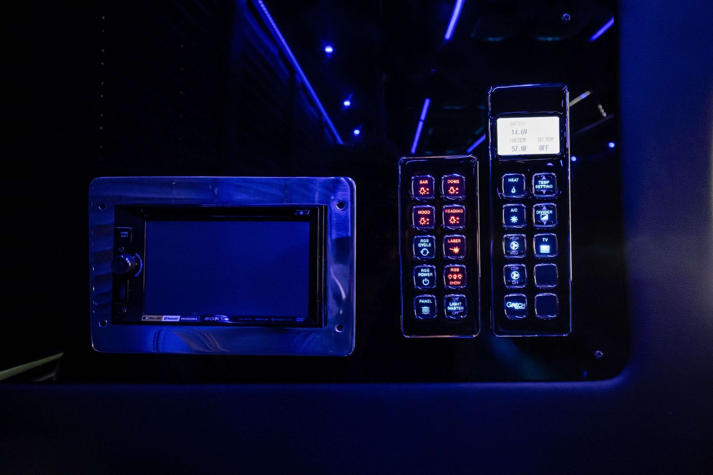Party bus control panels with touchscreen stereo and lit buttons for lights and climate