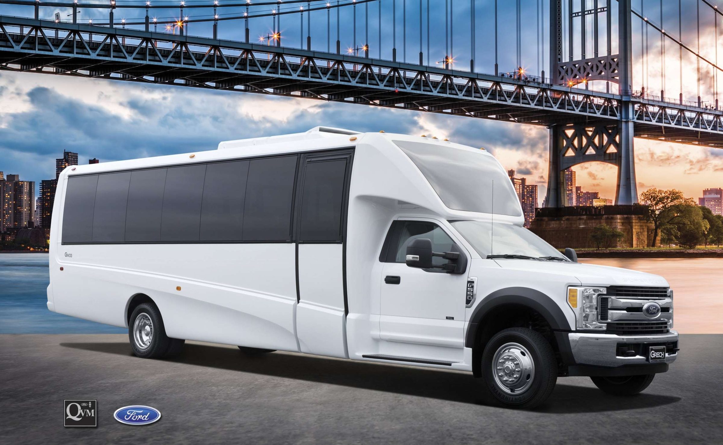 White Ford party bus parked in front of a large suspension bridge and city skyline