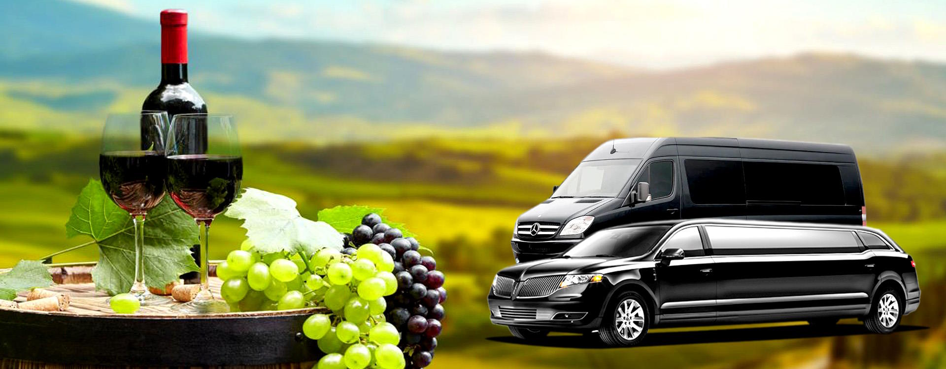 Red wine, grapes and a barrel beside a black Mercedes Sprinter van and stretch limousine